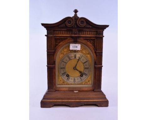 A German mantel clock, the 13 cm arched brass dial with a silvered chapter ring having Roman numerals, fitted an eight day mo