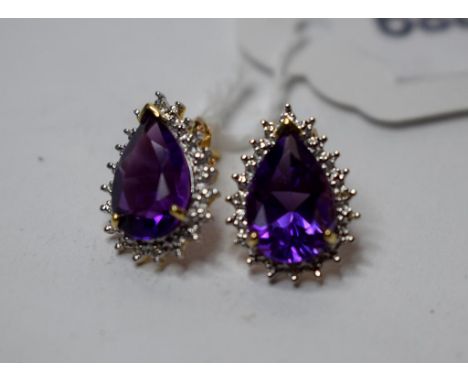 A pair of 9ct gold, pear shaped amethyst and diamond earrings