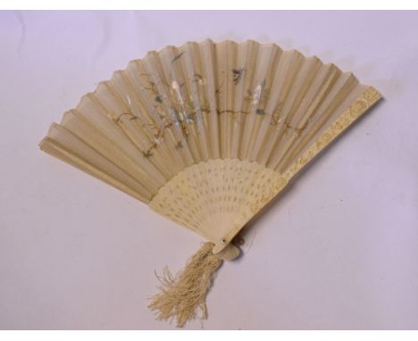 A 19th century Cantonese ivory fan, with embroidered silk, an early 20th century carved ivory elephant, a similar egg, and a 