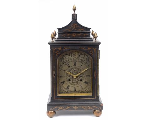 A mantel clock, the 10.5 cm arched square silvered dial with Roman numerals, fitted an eight day movement, in an ebonised cas