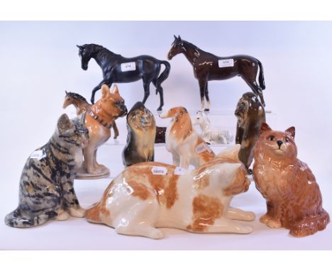 A Winstanley seated tabby cat, 22 cm high, another similar cat, a Beswick Persian Cat, seated, ginger, 1867, gloss, Beswick a