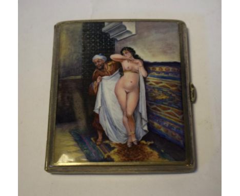 A silver plated and enamel cigarette case, the exterior decorated a Moroccan type scene, with an attendant wrapping a nude la