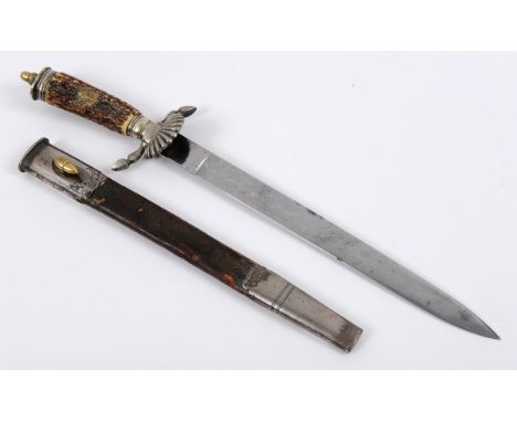 A German Hunting Association type dagger and scabbard, with a horn handle decorated a brass stags head and swastika, acorn mo