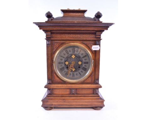 A Continental mantel clock, the 14 cm diameter metal dial with Roman numerals in an oak case, 42 cm high, and a Chinese famil