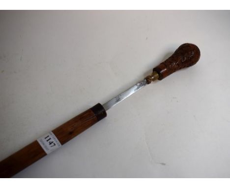 A German sword stick, with a carved bone handle in the form of a leopard's head, and a brass collar with a Gunther Wagner pla