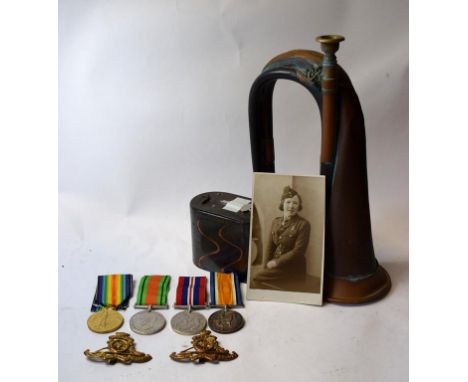 Assorted militaria, including cap badges, photographs, a bugle, and a money box (qty)