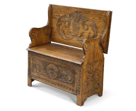 AN EARLY 20TH CENTURY CARVED OAK MONK'S BENCH with box seat. 91cm wide