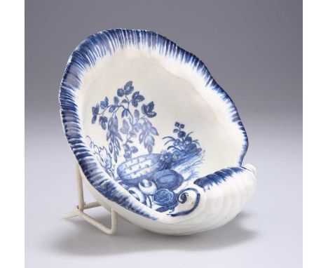 A CAUGHLEY SCALLOP-SHELL BUTTER DISH, CIRCA 1780 blue printed with vegetables, blue C mark. 13cm wideThe butter dish has a fe