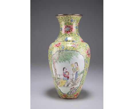 A CANTONESE ENAMEL VASE, 18TH/19TH CENTURY painted with two reserves with two ladies in a garden. 21.5cm high