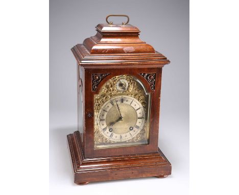 A MAHOGANY TABLE CLOCK, CIRCA 1900 with caddy top and brass carrying handle, the brass dial with silvered chapter, slow/fast 