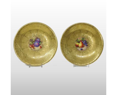 A pair of Royal Worcester porcelain cabinet plates, painted with fruit, each signed Freeman, gold marks to the reverse, 23cm 