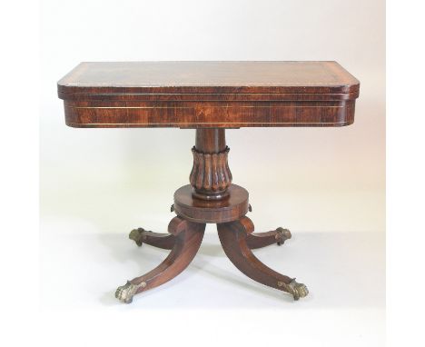 A Regency rosewood, crossbanded and brass strung D shaped folding card table, with a hinged top, on a fluted column and platf