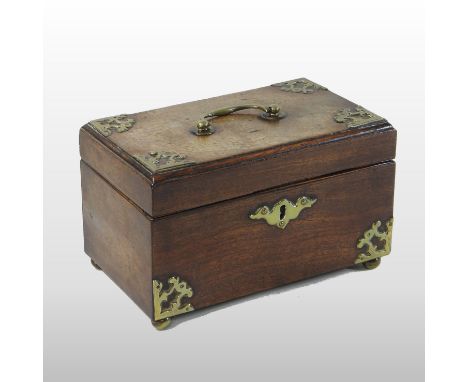 A George III mahogany tea caddy, of plain rectangular shape, with brass mounts and a fitted interior, on brass ball feet, 22c