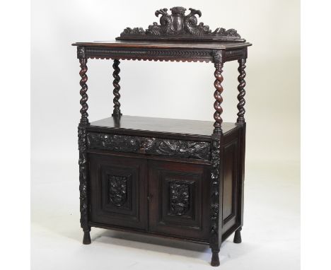 A Victorian carved oak buffet, the gallery carved with a crown and shield flanked by dolphins, on barley twist supports above