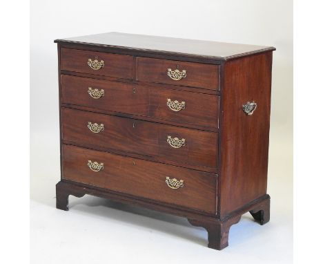 A 19th century mahogany chest, containing two short above three drawers, flanked by carrying handles, standing on bracket fee
