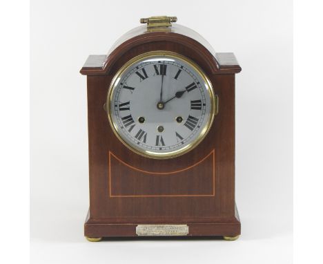 An early 20th century mahogany cased bracket clock, having a three train movement, striking on gongs, with a silver presentat