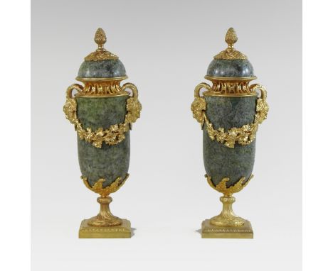 A pair of continental green marble and gilt metal mounted cassolettes, each mounted with a pineapple finial above twin faun m