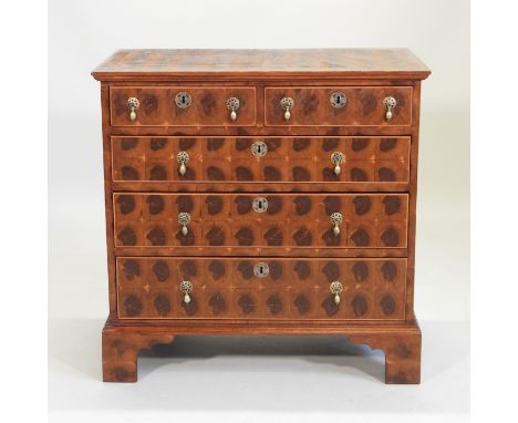 A William and Mary style oyster veneered chest, the top with circular boxwood inlaid, containing two short above three long d