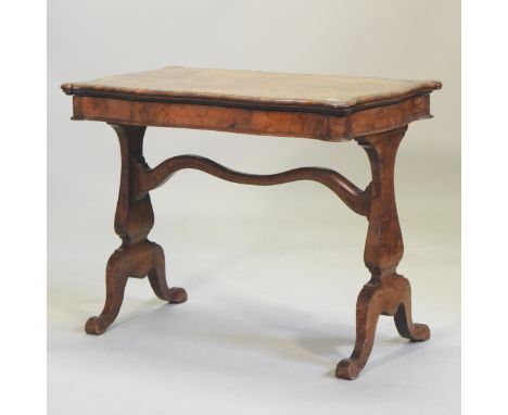 A Victorian walnut card table, the shaped top lifting to reveal a baize interior, on vase shaped supports and splayed legs, 9