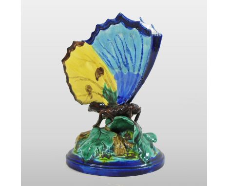 A rare Royal Worcester majolica posy vase, in the form of a butterfly with open wings, seated on leaves, on a cobalt blue foo