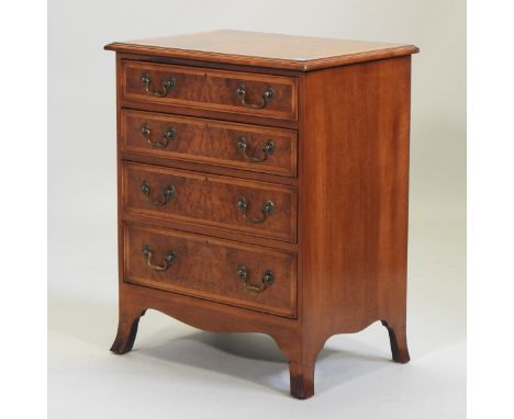 A George III style walnut and crossbanded chest of drawers, of small proportions, containing four long drawers on swept brack