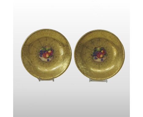 A pair of Royal Worcester porcelain cabinet plates, painted with fruit, each signed Freeman, gold marks to the reverse, 23cm 