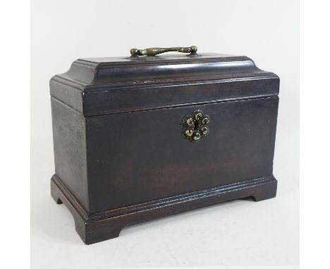 A George III mahogany tea caddy, the cavetto moulded top lifting to reveal a fitted interior, with a secret drawer, on bracke