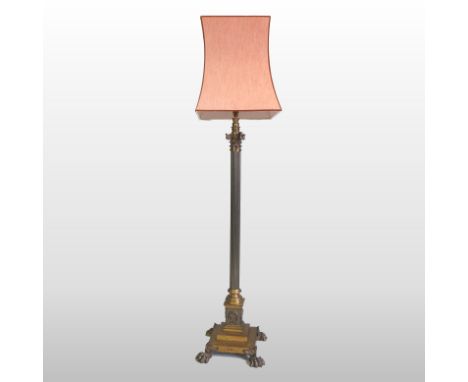 A Victorian brass standard lamp and shade, in the form of a fluted Corinthian column, on paw feet, 160cm high