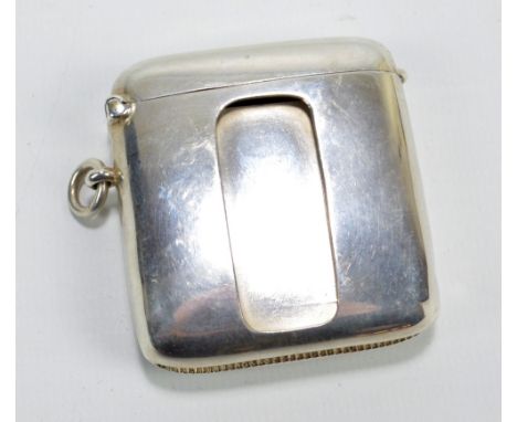 WILLIAM HAIR HASELER; a George V hallmarked silver rectangular vesta case of plain form with striker to the base and addition