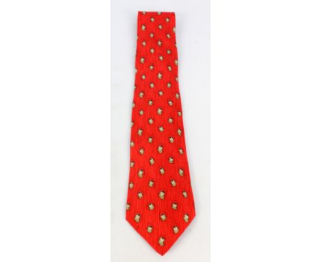 HERMÈS; a silk tie decorated with owl heads on stripy crimson ground.