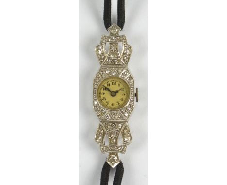 An early 20th century platinum and diamond manual wind lady's cocktail wristwatch, the circular dial set with Arabic numerals