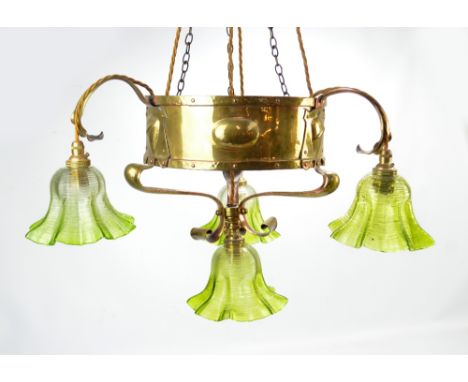 An Arts and Crafts brass ceiling lamp of circular form with stud decorated bands and three stylised floral coppered branches,