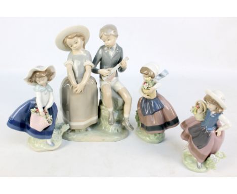 Three Lladro figures of girl holding bucket of flowers and a figure group of a boy playing mandolin and a girl (4).