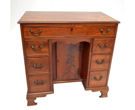 A reproduction George II style mahogany kneehole desk of small proportions with single drawer above two formations of three d