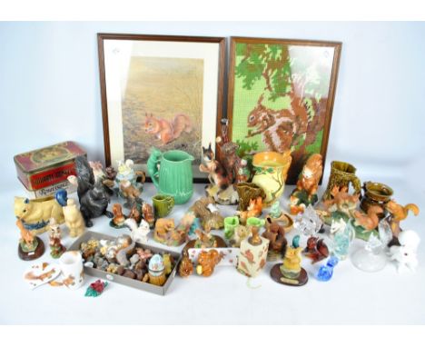 A large collection of predominantly ceramic figures of squirrels, also glass examples and various related items to include ju