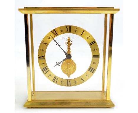 JAEGER LECOULTRE; a brass cased mantel clock, the circular dial set with Roman numerals, the exposed movement with manufactur