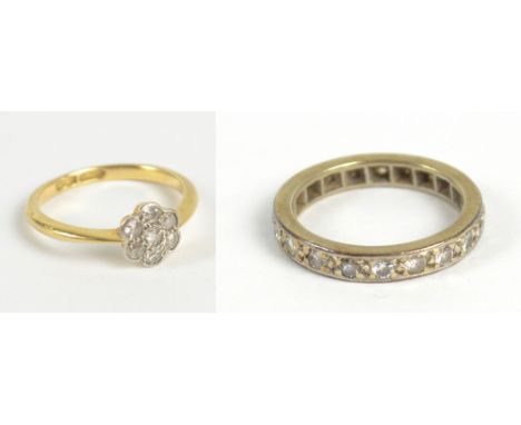 An 18ct yellow gold and diamond daisy ring, size K, approx 2.2g, and an unmarked metal and 19 diamond full eternity ring, siz