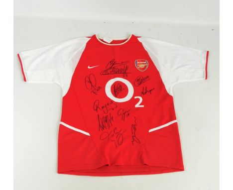 ARSENAL; a replica short sleeved shirt signed by members of The Invincibles, signatures are Bergkamp, Henry, Pires, Campbell,