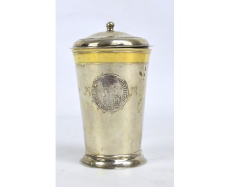A late 18th century French white metal tapering beaker with cover of plain form set with two Louis XV coins and another, with