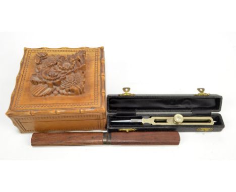 A Black Forest square trinket box, carved in relief with floral motifs with butterflies to the lid and bamboo effect edges, 1
