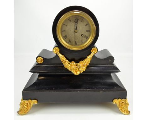 A late 19th century black slate mantel clock with gilt mounts, the circular silver dial set with Roman numerals, diameter 8.8