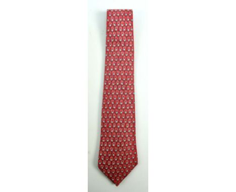 HERMÈS; a silk tie decorated with honeycomb motif on a red ground, boxed.