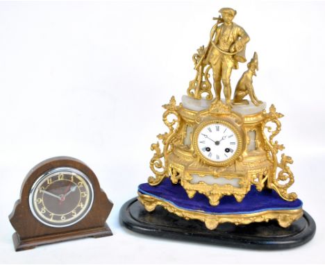A late 19th century French gilt metal and alabaster detailed mantel clock surmounted with figure of huntsman with a greyhound