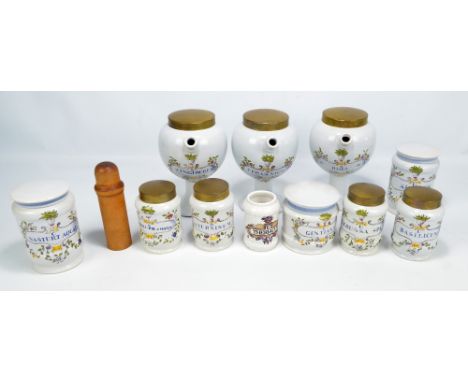 A group of ceramic pharmaceutical jars to include a set of three globular footed examples and with brass covers, height 21.5c