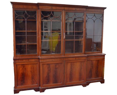 An Edwardian mahogany, satinwood banded and line inlaid breakfront bookcase, the upper section with dentil moulded cornice ab