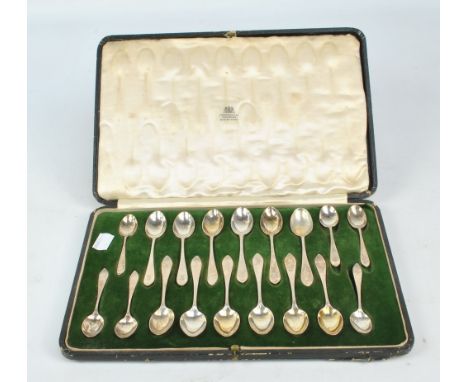 WAKELY & WHEELER; a cased set of twelve coffee spoons with Celtic point finials, London 1915, length 11cm, and a set of six s