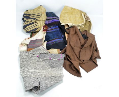 A quantity of Japanese textiles and garments including a waistcoat, rustic haori, various panels, etc.
