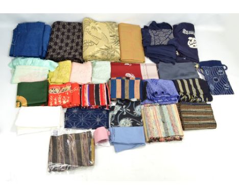 A quantity of Japanese textiles including sakiori obi, ragobi pieces, Kaya netting, a silk shibori kimono shawl, etc.