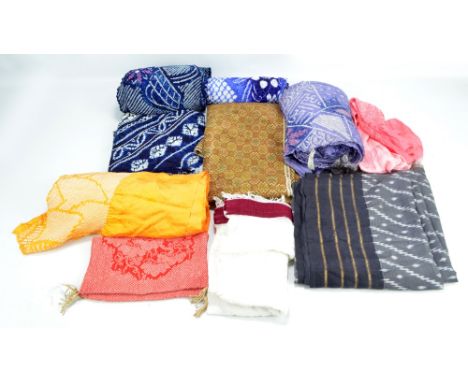 A quantity of Japanese textiles including a rinzu silk obiage, a shibori yukata bolt, a further bolt, etc.