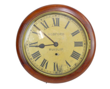 A circa 1900 mahogany and stained beech circular wall clock with painted dial set with Roman numerals inscribed 'Bedford, Rui